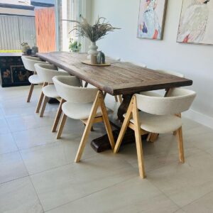 Customer dining room with a rustic timber table and cream chairs